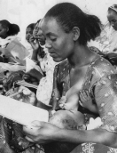 Eritrean retreat area: Mother learns to
                            read.