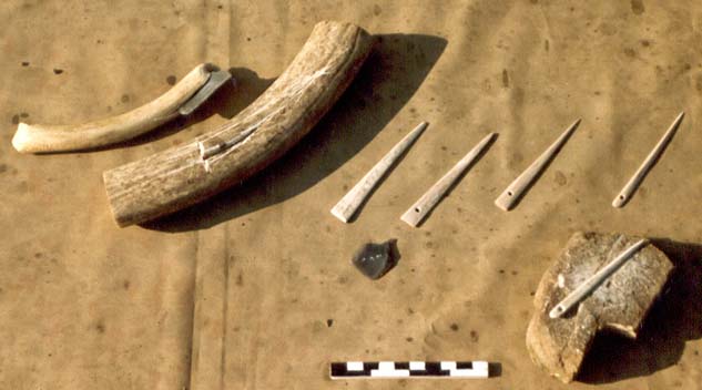 Die
                    Herstellung einer Knochennadel aus Knochen, Klinge
                    und spitzem Stein