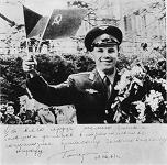 Gagarin in Prague: Gagarin with
                            flowers, waving Czech and "Soviet"
                            little flags.