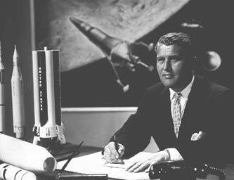 16 Sep 1960: Wernher von Braun in his
                        office with Disney space ships in the
                        background, here a landing module with only one
                        engine. It seems Braun thinks only in Disney
                        dimensions yet, without thought of real
                        physics.