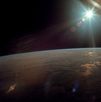 Apollo 11 photo no. AS11-36-5293: sight
                        from an Earth orbit to the Earth with light show
                        effect by the atmosphere. The photo can be from
                        any flight around the Earth