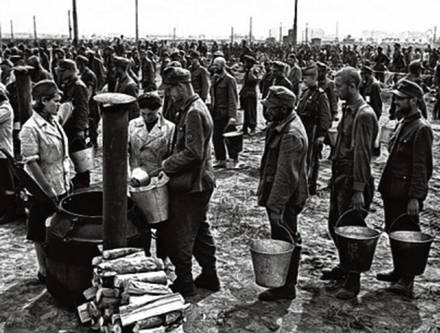 German prisoners of war getting soup in a
                        Russian prisoner of war camp after 1945