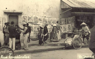 The port town of Haiphong in North Vietnam,
                    Tonking Street with newspapers+rickshaw 1920 appr.